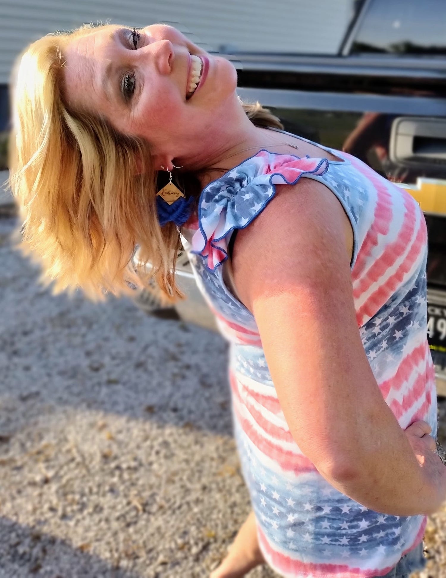SO CUTE! I am a true American Loving Large/X-Large wearing X-Large in this cool Patriotic Poly rayon jersey stars and stripe tank top featuring ruffle shoulder details 65% POLYESTER 30% RAYON 5% SPANDEX Tank! A cool addition to your wardrobe for the 4th!