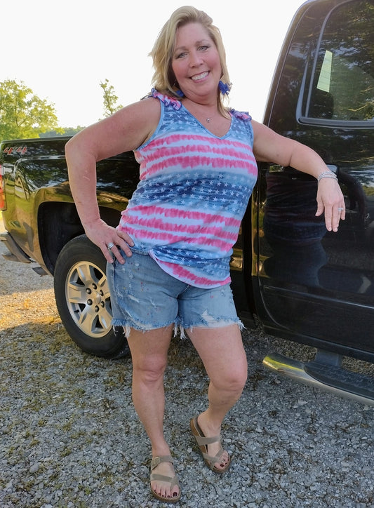 SO CUTE! I am a true American Loving Large/X-Large wearing X-Large in this cool Patriotic Poly rayon jersey stars and stripe tank top featuring ruffle shoulder details 65% POLYESTER 30% RAYON 5% SPANDEX Tank! A cool addition to your wardrobe for the 4th!